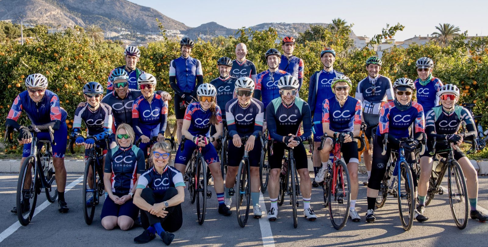 Cycling club members posing together with their road bikes after a club ride