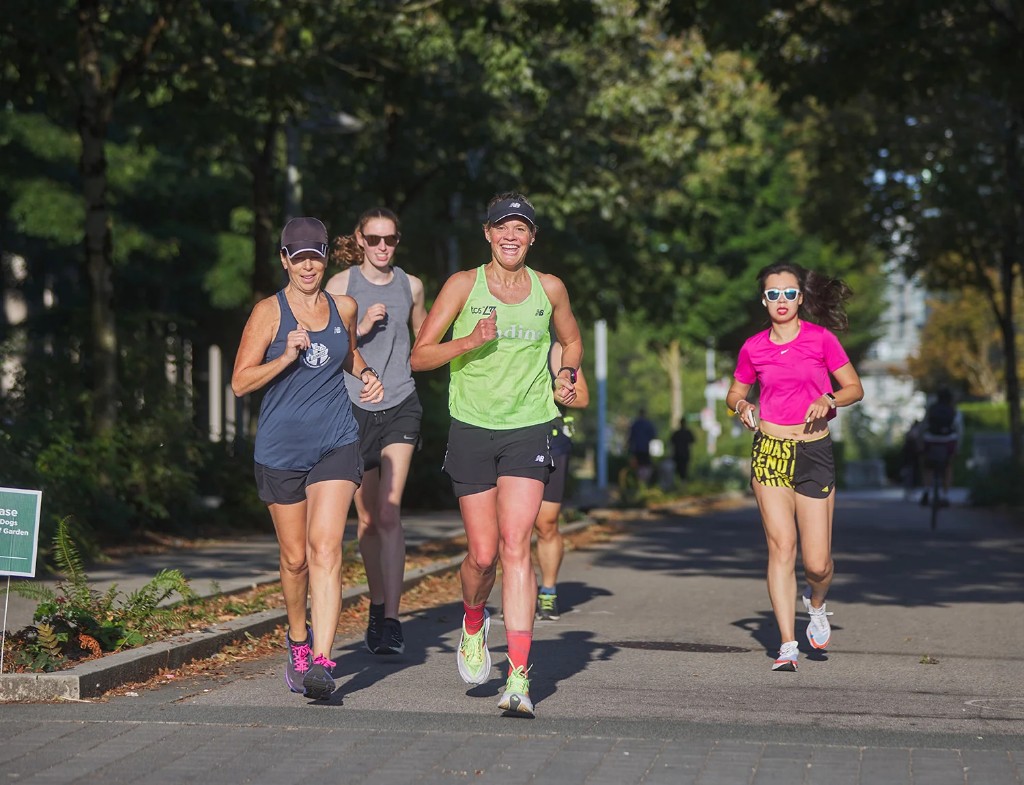 Run club members jogging together outdoors